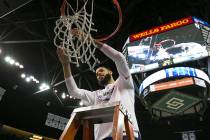 Nevada forward Cody Martin (11) cuts down the net after his teams win over San Diego State in an NCAA college basketball game in Reno, Nev., Saturday, March 9, 2019. (AP Photo/Tom R. Smedes)