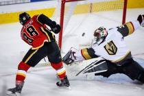 Vegas Golden Knights goalie Malcolm Subban, right, lets in a goal from Calgary Flames' Andrew Mangiapane during first period NHL hockey action in Calgary, Alberta, Sunday, March 10, 2019. (Jeff Mc ...