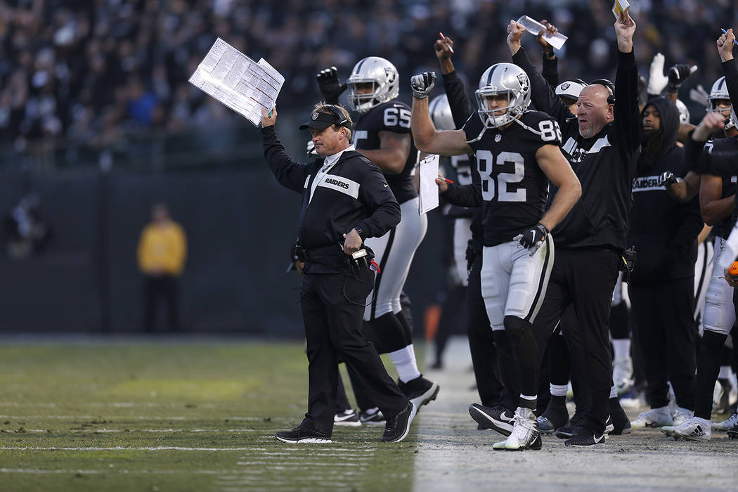 Oakland Raiders head coach Jon Gruden, left, celebrates after a touchdown against the Pittsburgh Steelers during the second half of an NFL football game in Oakland, Calif., Sunday, Dec. 9, 2018. ( ...