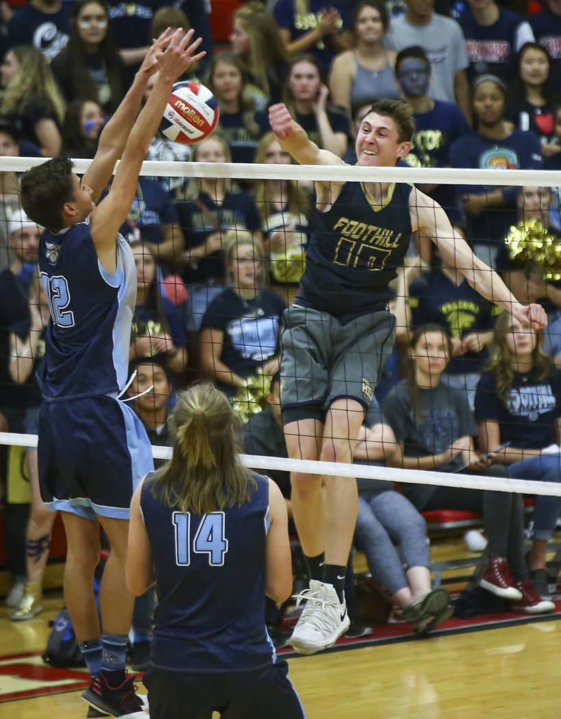 Centennial's Austin Anderson (12) blocks a shot from Foothill's Caleb Stearman (10) during the third set of the Class 4A state volleyball championship match at Arbor View High School in Las Vegas ...