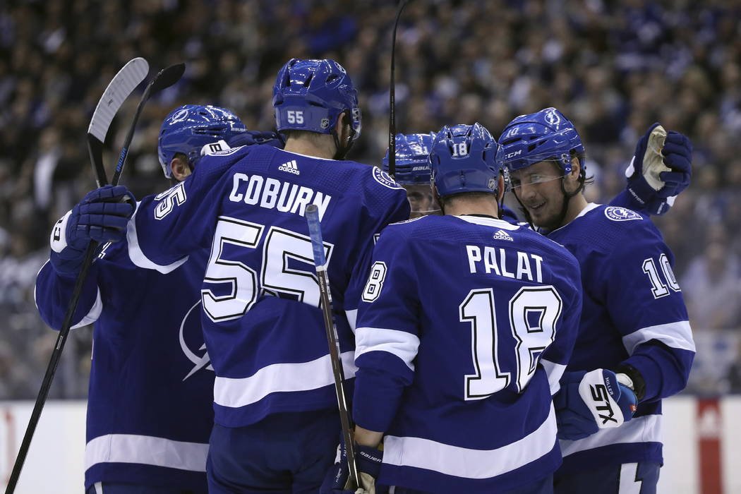 Tampa Bay Lightning defenseman Braydon Coburn (55), left wing Ondrej Palat (18), and center J.T. Miller (10) celebrate a second-period goal against the Toronto Maple Leafs in NHL hockey game actio ...