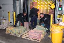 This Feb. 28, 2019 photo provided by U. S. Customs and Border Protection shows Customs agents unloading a truck containing 3,200 pounds of cocaine in 60 packages, where it was seized at the Port o ...