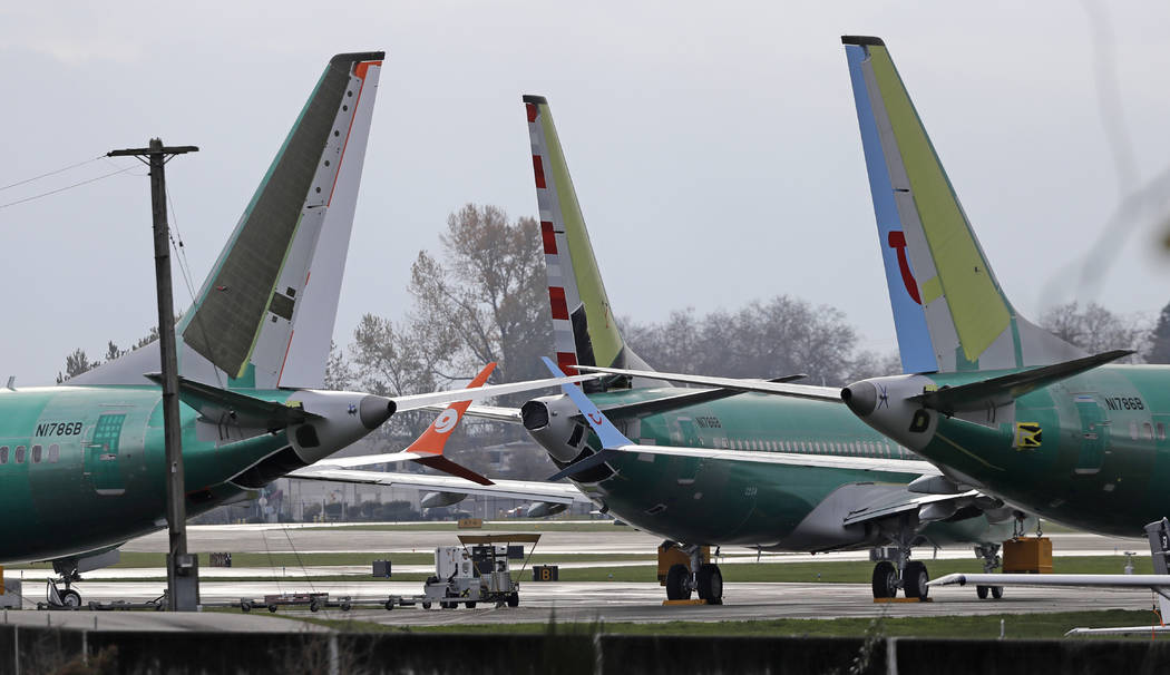 FILE- In this Nov. 14, 2018, file photo Boeing 737 MAX 8 planes are parked near Boeing Co.'s 737 assembly facility in Renton, Wash. Investigators were rushing to the scene of a devastating plane c ...