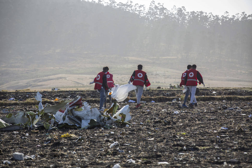 Rescuers work at the scene of an Ethiopian Airlines flight crash near Bishoftu, or Debre Zeit, south of Addis Ababa, Ethiopia, Monday, March 11, 2019. A spokesman says Ethiopian Airlines has grou ...