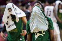 Chicago State senior guard Delshon Strickland (2) walks off the court with his face covered after the Cougars lost to New Mexico State 86-49 in the opening round of the Western Athletic Conference ...