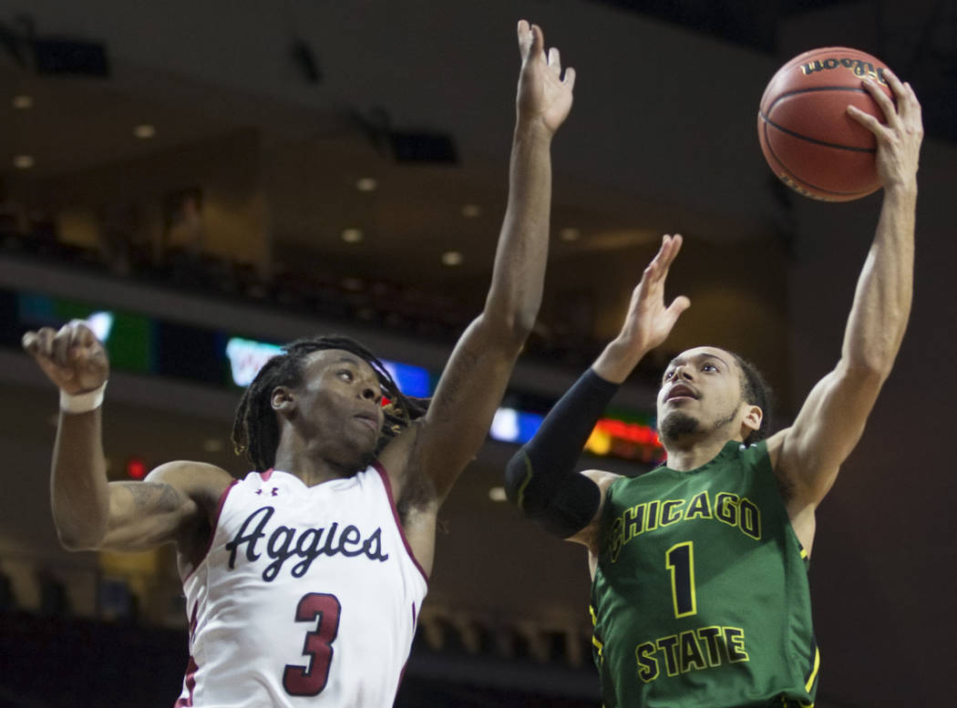 Chicago State senior guard Rob Shaw (1) slices to the rim past New Mexico State junior guard Terrell Brown (3) in the first half of the opening round of the Western Athletic Conference tournament ...