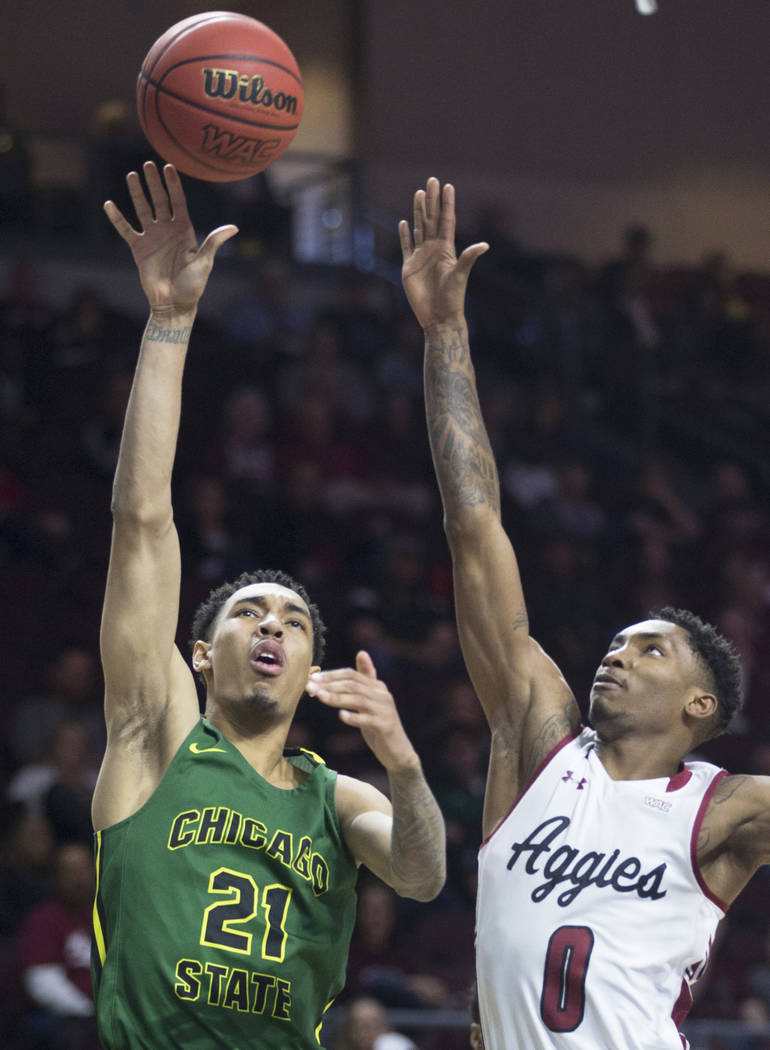 Chicago State sophomore forward Cameron Bowles (21) shoots a jump hook over New Mexico State freshman forward Berrick JeanLouis (0) in the second half of the opening round of the Western Athletic ...