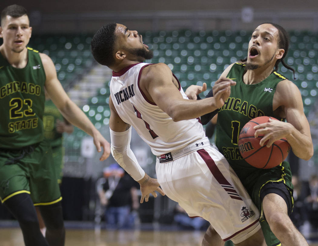 Chicago State senior guard Rob Shaw (1) collides with New Mexico State junior guard Shunn Buchanan (1) in the first half of the opening round of the Western Athletic Conference tournament on Thurs ...