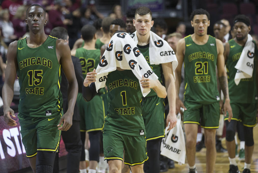 Chicago State senior guard Rob Shaw (1) walks off the court with his face covered, along with teammate Noah Bigirumwami (15), after the Cougars lost to New Mexico State 86-49 in the opening round ...