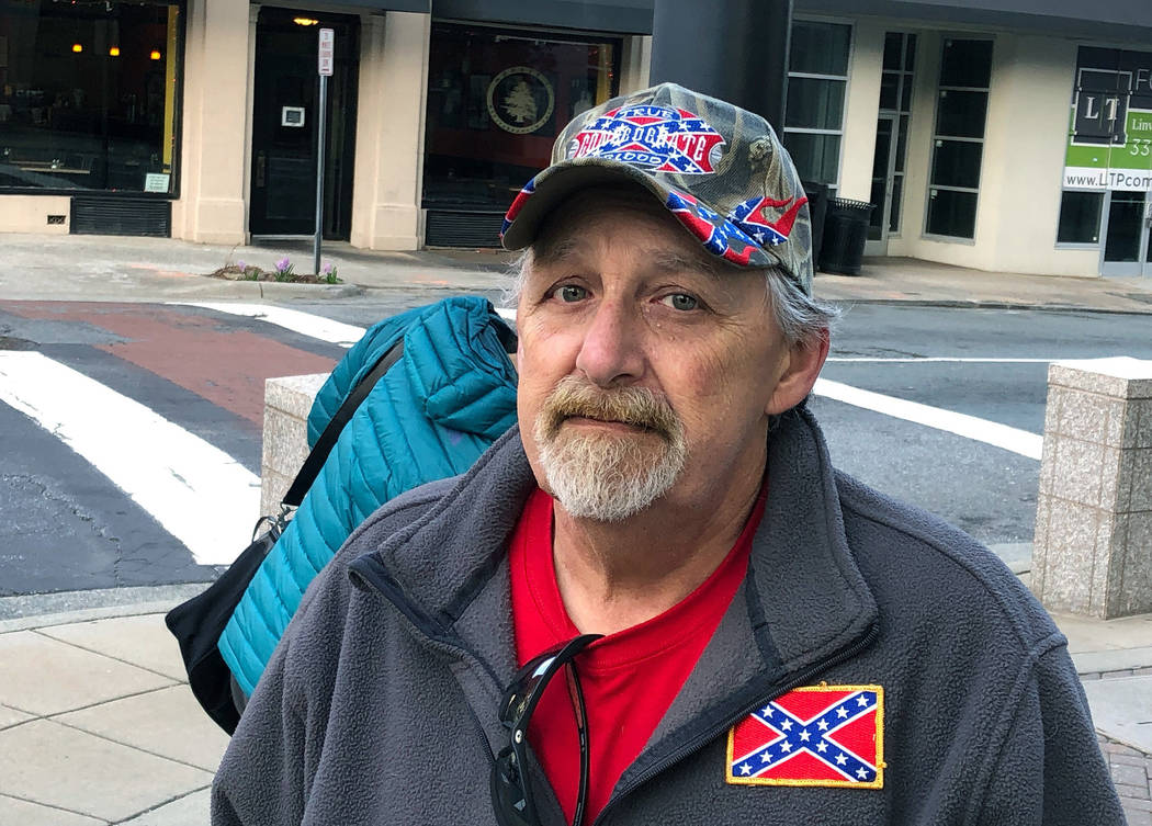 Howard Snow stands across from a Confederate statue in downtown Tuesday, March 12, 2019, in Winston-Salem, N.C. Snow says the city is wasting money by taking the statue down and that the money can ...