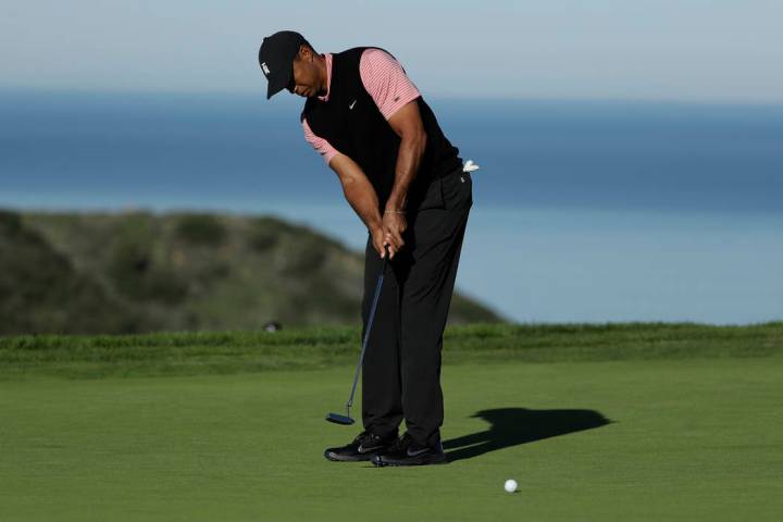 Tiger Woods putts on the 10th green of the South Course at Torrey Pines Golf Course during the final round of the Farmers Insurance golf tournament Sunday, Jan. 27, 2019, in San Diego. (AP Photo/G ...