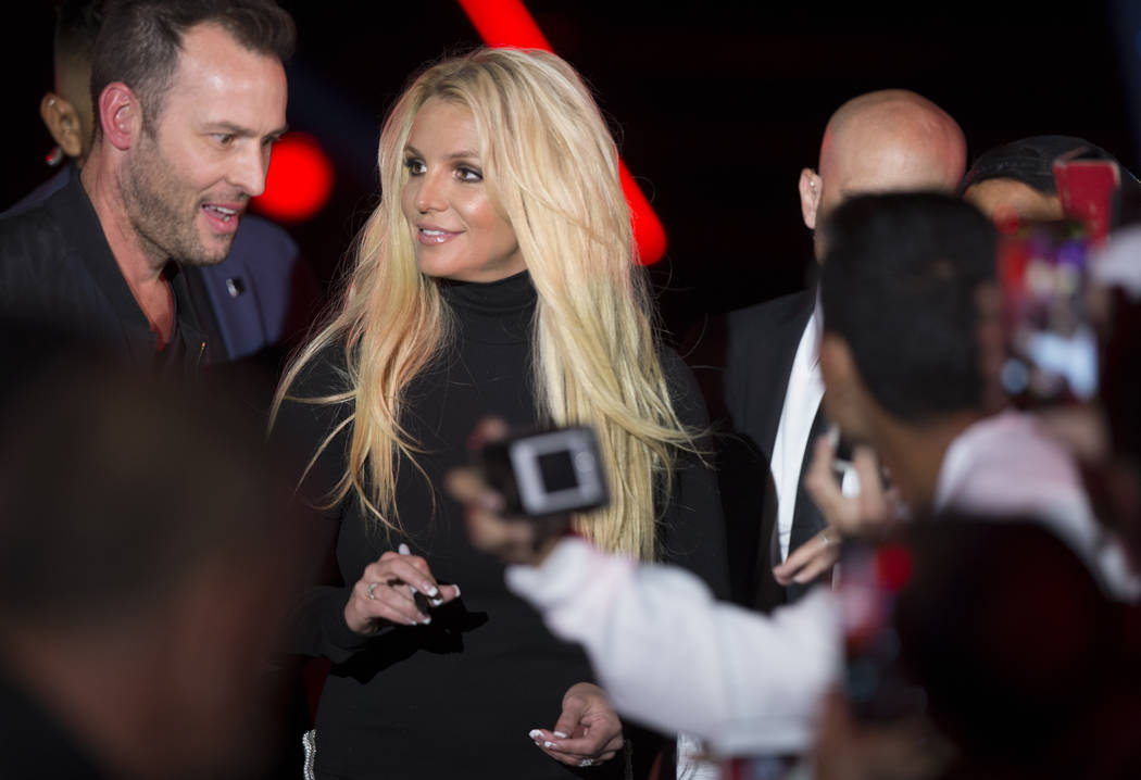 Britney Spears signs autographs during an event to announce her new residency at The Park Theater at Park MGM on Thursday, Oct. 18, 2018, outside T-Mobile Arena, in Las Vegas. (Benjamin Hager/Las ...