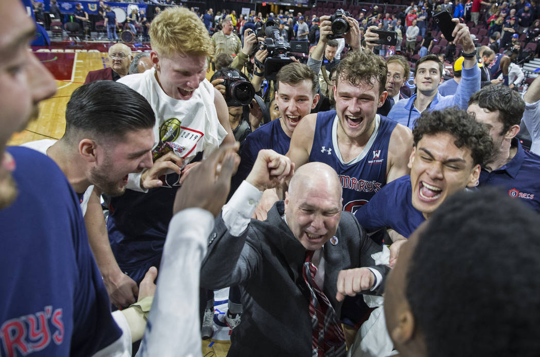 St. Mary's head coach Randy Bennett, middle, celebrates with his team after the Gaels upset Gonzaga 60-47 to win the West Coast Conference championship on Tuesday, March 12, 2019, at Orleans Arena ...