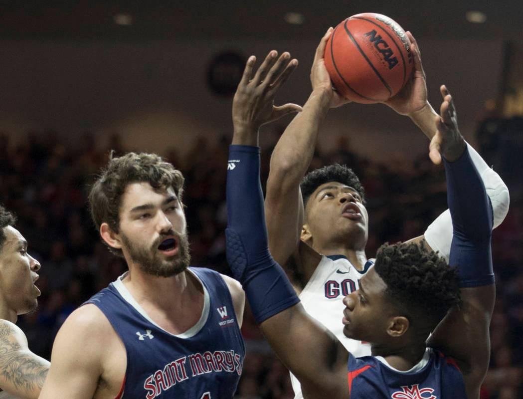 Gonzaga junior forward Rui Hachimura (21) grabs a rebound over St. Mary's sophomore forward Malik Fitts (24) and senior center Jordan Hunter (1) in the first half during the West Coast Conference ...