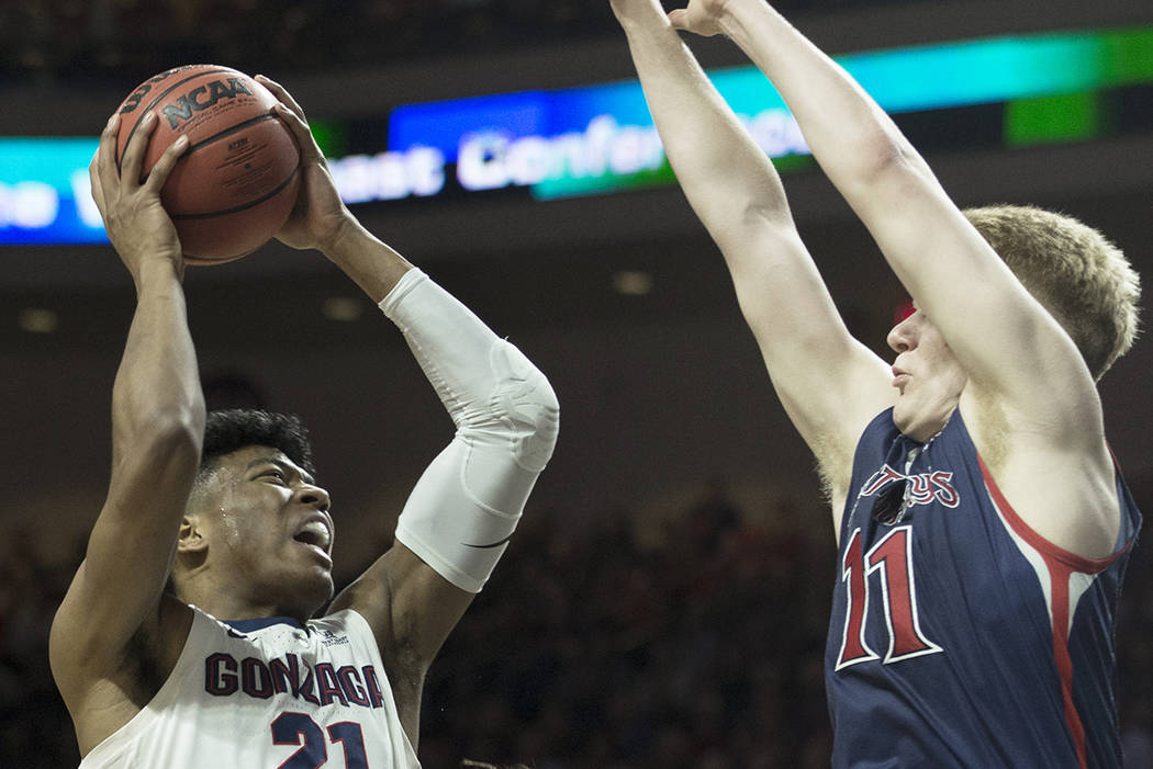 Gonzaga junior forward Rui Hachimura (21) drives over St. Mary's freshman forward Matthias Tass (11) in the first half during the West Coast Conference finals game on Tuesday, March 12, 2019, at O ...