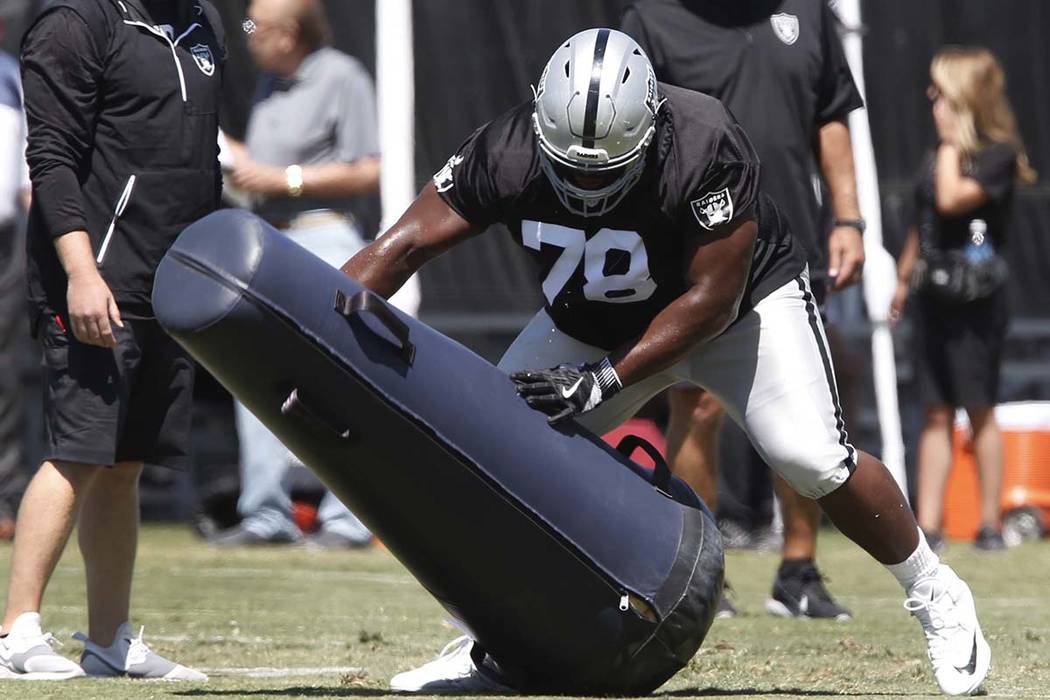 The Oakland Raiders defensive tackle Justin Ellis hits the tackling dummy during the second day of teams practice at Raiders Napa Valley training complex in Napa., Calif., on Sunday, July 30, 2017 ...