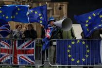 An anti-Brexit remain in the European Union supporter shouts slogans during a protest outside the Houses of Parliament in London, Tuesday, March 12, 2019. British Prime Minister Theresa May faced ...