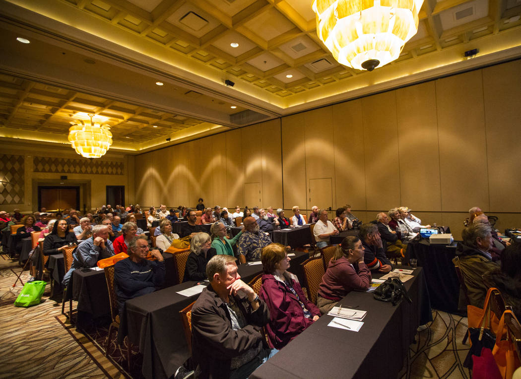 Attendees listen to a presentation by Faith Alchorn-Selk, a sales support representative with Prestige Travel, not pictured, during the fifth annual AgeWell Expo at the Rio Convention Center in La ...