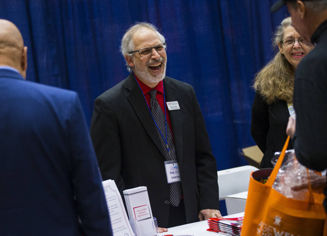 Robert Levrant, director of the Osher Lifelong Learning Institute, or OLLI, at UNLV, talks with attendees during the fifth annual AgeWell Expo at the Rio Convention Center in Las Vegas on Saturday ...