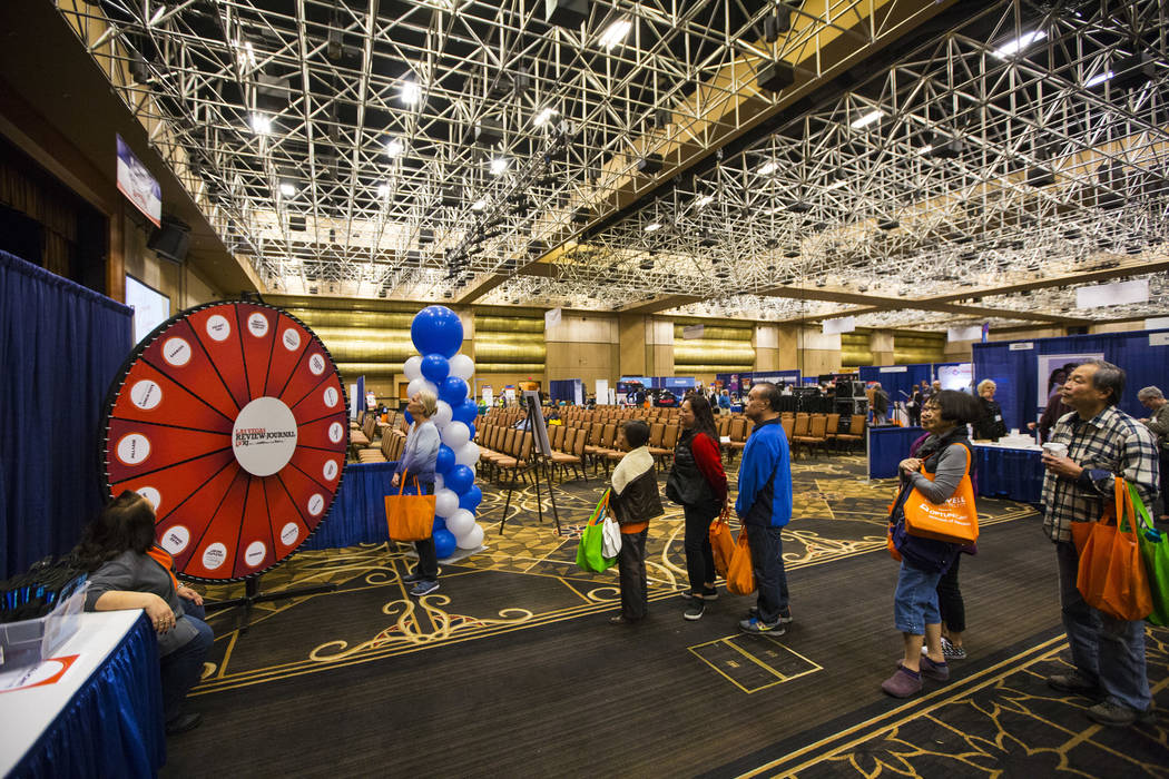 Attendees line up for a Review-Journal promotional giveaway during the fifth annual AgeWell Expo at the Rio Convention Center in Las Vegas on Saturday, March 16, 2019. (Chase Stevens/Las Vegas Rev ...