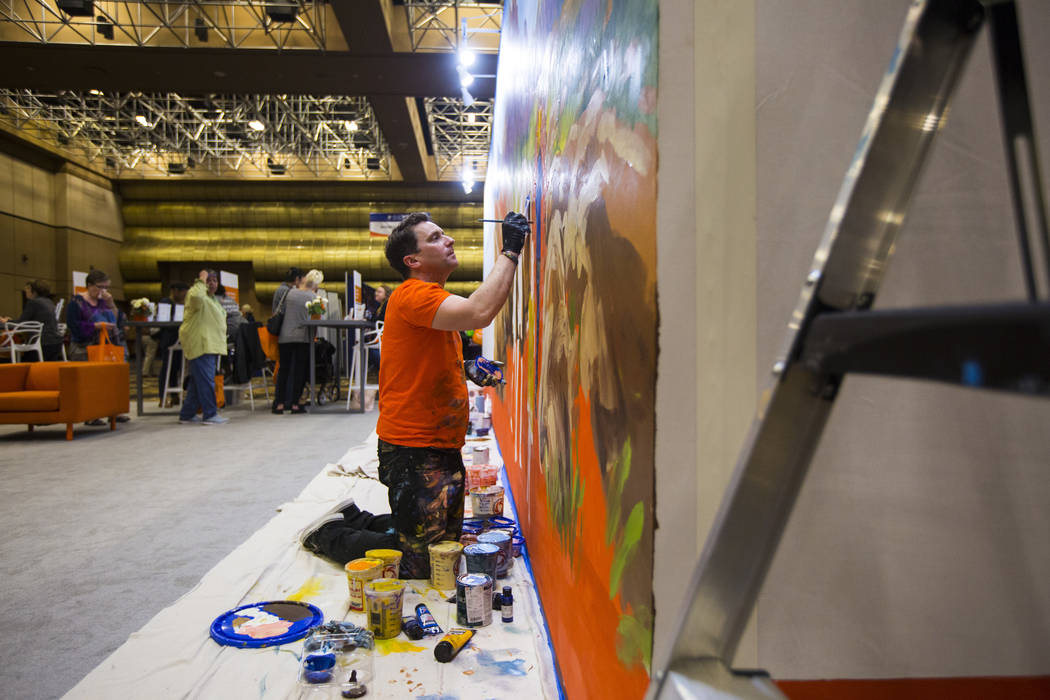 Mural artist Kris Friesen works on a piece at the OptumCare booth during the fifth annual AgeWell Expo at the Rio Convention Center in Las Vegas on Saturday, March 16, 2019. (Chase Stevens/Las Veg ...