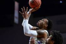 Grand Canyon guard Carlos Johnson (23) jumps up to take a shot while being guarded by Seattle guard/forward Riley Grigsby (35) in the first half of the opening round of the Western Athletic Confer ...