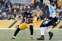Pittsburgh Steelers running back Le'Veon Bell (26) tries to get past Jacksonville Jaguars defensive end Dante Fowler (56) during the second half of an NFL divisional football AFC playoff game in P ...