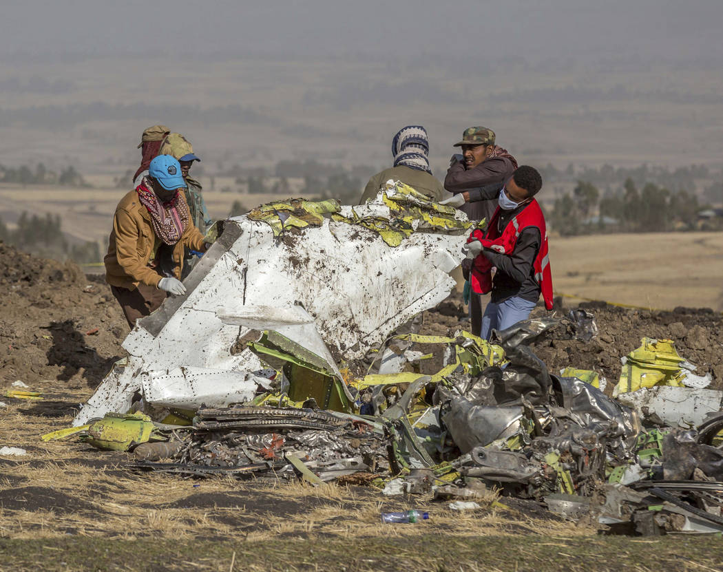 Rescuers work at the scene of an Ethiopian Airlines flight crash near Bishoftu, or Debre Zeit, south of Addis Ababa, Ethiopia, Monday, March 11, 2019. A spokesman says Ethiopian Airlines has grou ...