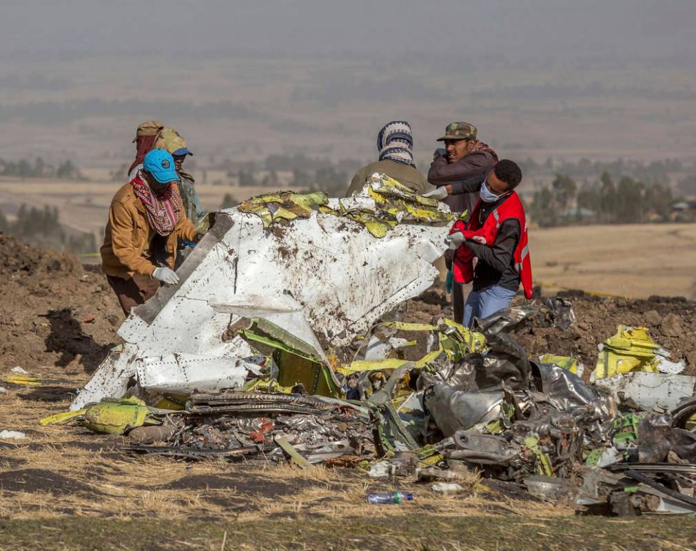 Rescuers work at the scene of an Ethiopian Airlines flight crash near Bishoftu, or Debre Zeit, south of Addis Ababa, Ethiopia, Monday, March 11, 2019. A spokesman says Ethiopian Airlines has grou ...