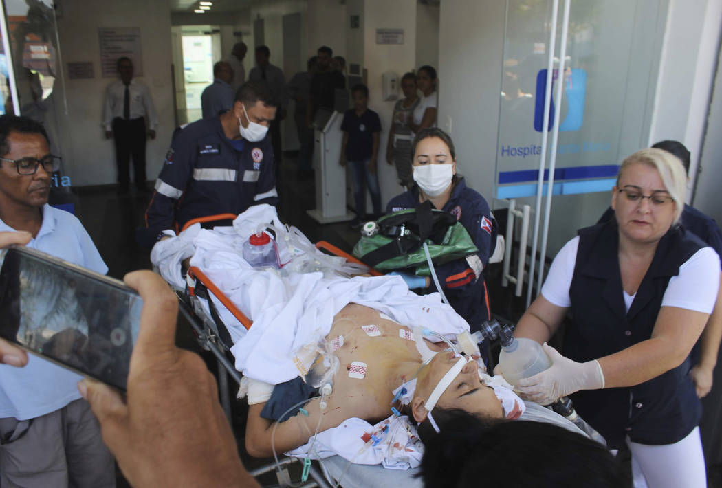 A teenager who was injured during a shooting inside the Raul Brasil State School, is carried on a gurney into a hospital, in Suzano, Brazil, Wednesday, March 13, 2019. The state government of Sao ...