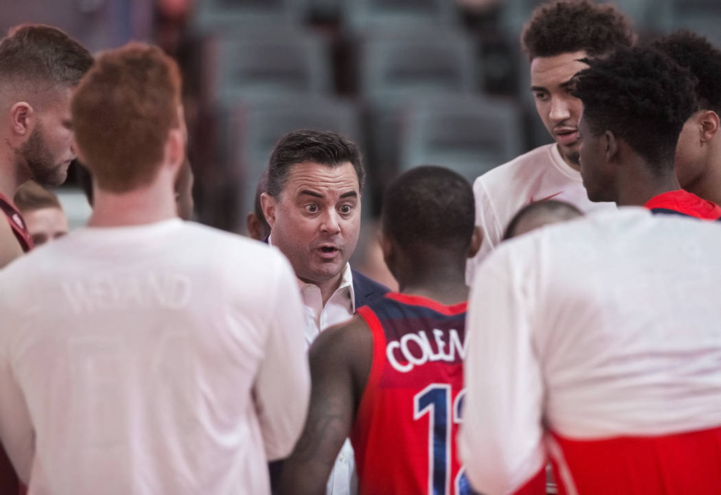 Arizona head coach Sean Miller, middle, coaches up his team before the start of the Wildcats Pac-12 tournament game with USC on Wednesday, March 13, 2019, at T-Mobile Arena, in Las Vegas. (Benjami ...