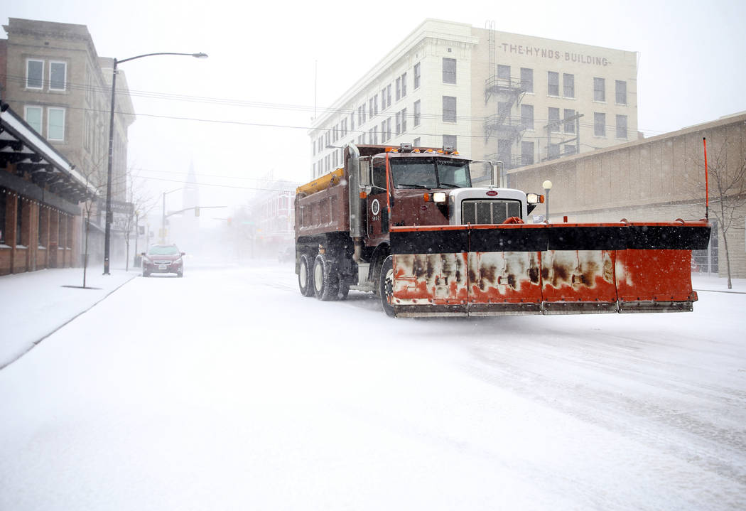 A snow plow rumbles north on Capitol Avenue during a blizzard on Wednesday, March 13, 2019, in Cheyenne, Wyo. White-out conditions closed I-80, I-25, and U.S. 85, effectively closing off the state ...