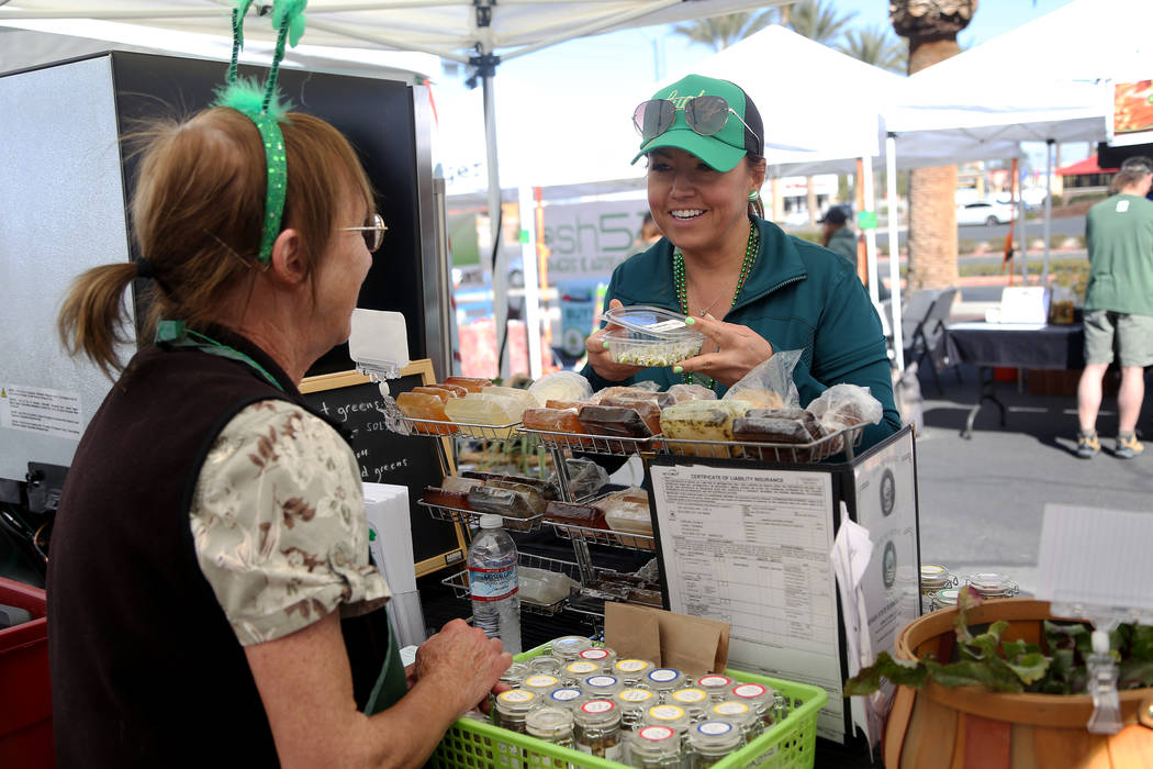 Carrie Hogan, founder of the Fresh52 farmers and artisans market, speaks to vendor Diane Greene at her booth Herbs by Diane at the Fresh52 farmers and artisans market in Las Vegas, Sunday, March 1 ...