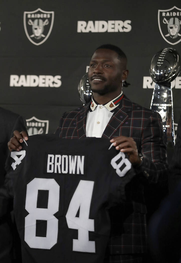 Oakland Raiders wide receiver Antonio Brown holds his jersey during an NFL football news conference, Wednesday, March 13, 2019, in Alameda, Calif. (AP Photo/Ben Margot)