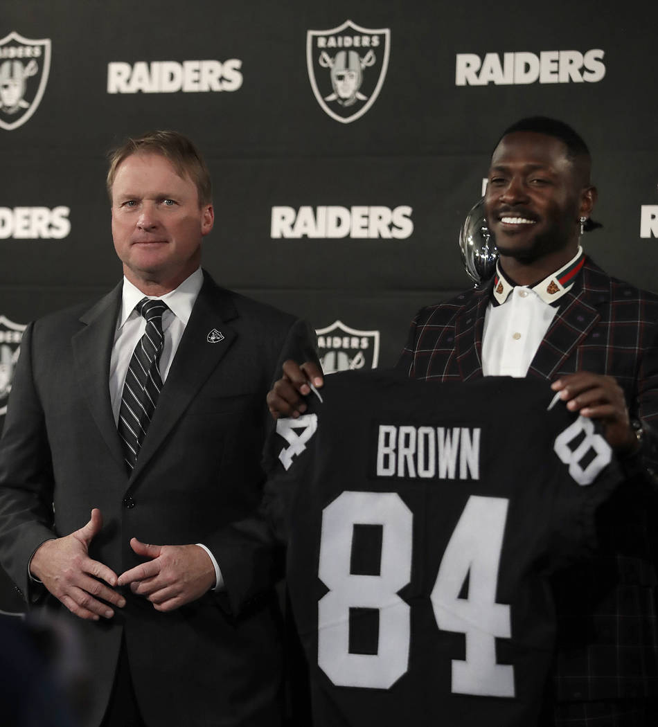 Oakland Raiders wide receiver Antonio Brown, right, holds his jersey beside coach Jon Gruden during an NFL football news conference, Wednesday, March 13, 2019, in Alameda, Calif. (AP Photo/Ben Margot)