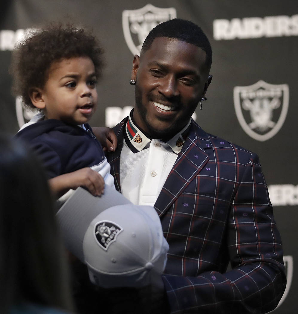 Oakland Raiders wide receiver Antonio Brown holds his son Apollo prior to an NFL football news conference, Wednesday, March 13, 2019, in Alameda, Calif. (AP Photo/Ben Margot)