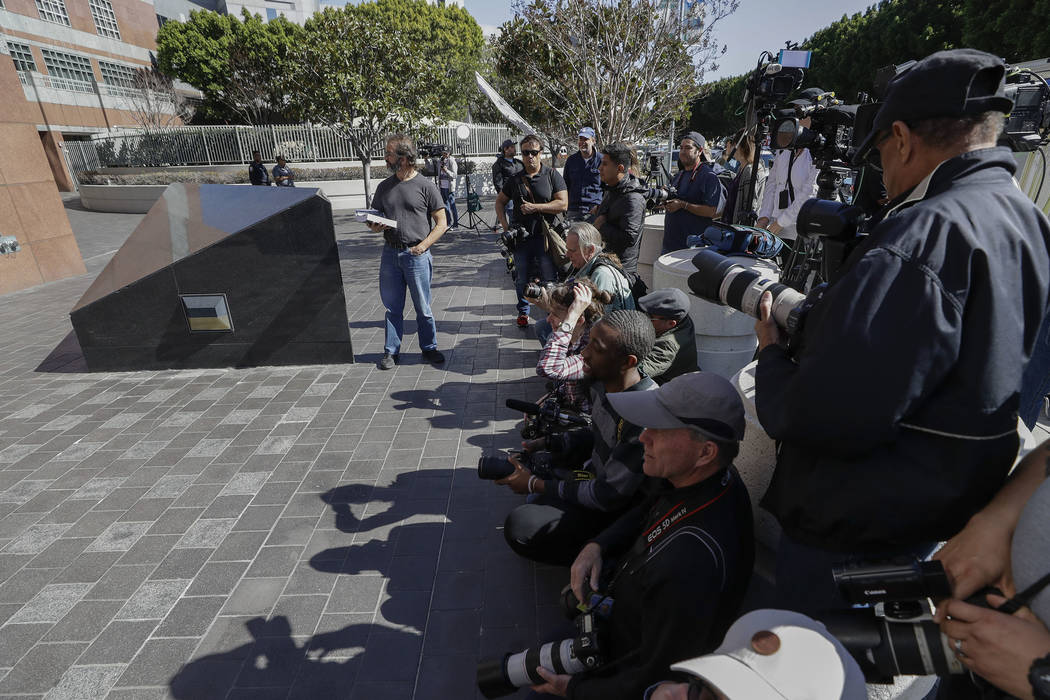 Members of the media wait outside the federal courthouse for actress Lori Loughlin Wednesday, March 13, 2019, in Los Angeles. Fifty people, including actress Loughlin, were charged Tuesday in a sc ...