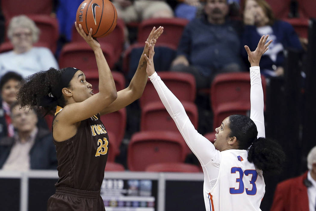 Boise State's Braydey Hodgins hoist the MVP trophy following the team's NCAA college basketball game against Wyoming for the Mountain West Conference women's tournament championship Wednesday, Mar ...