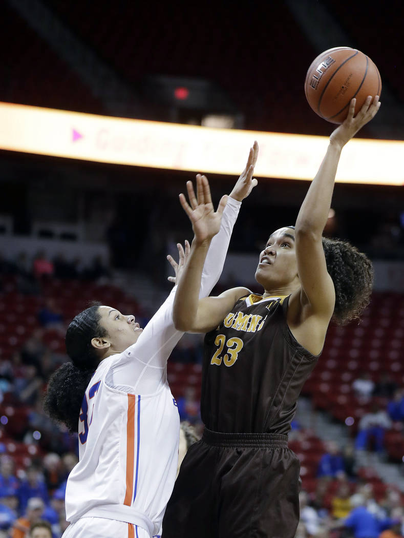 Boise State's Joyce Harrell defends as Wyoming's Bailee Cotton (23) shoots during the second half of an NCAA college basketball game for the Mountain West Conference women's tournament championshi ...