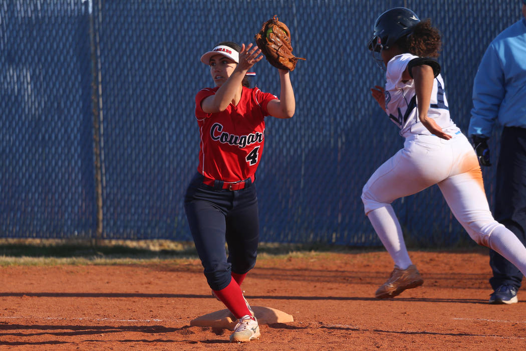 Coronado's Aleah Baldonado (4) makes a catch for an out at first base against Centennial's Maddie Kallfelz (14) in the outfield against Centennial in the softball game at Centennial High School in ...