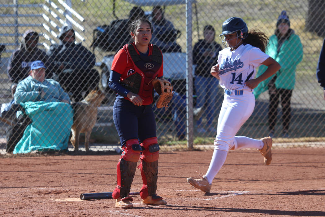 Centennial's Maddie Kallfelz (14) runs home for a run after a hit by Tatum Huntly (9) as Coronado's catcher Isabel Rodriguez (3) looks on in the softball game at Centennial High School in Las Vega ...