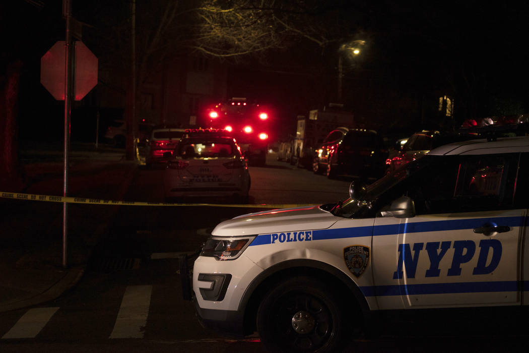 New York Police Department and New York City Fire Department units respond to a report of shots fired Wednesday, March 13, 2019, in the Todt Hill section of the Staten Island borough of New York. ...