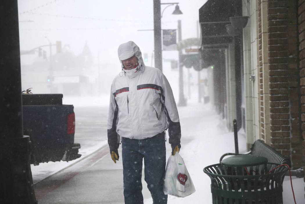 A man walks along 17th Street during a blizzard on Wednesday, March 13, 2019, in Cheyenne. White-out conditions closed I-80, I-25, and U.S. 85, effectively closing off the state capital from Nebra ...