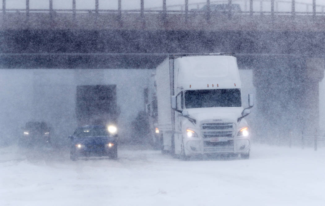 Traffic stops in the eastbound lanes of Interstate 70 near Tower Road as a late winter storm packing hurricane-force winds and snow sweeps over the intermountain West Wednesday, March 13, 2019, in ...