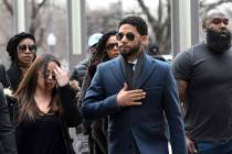 "Empire" actor Jussie Smollett, center, arrives at the Leighton Criminal Court Building for his hearing on Thursday, March 14, 2019, in Chicago. Smollett is accused of lying to police about being ...