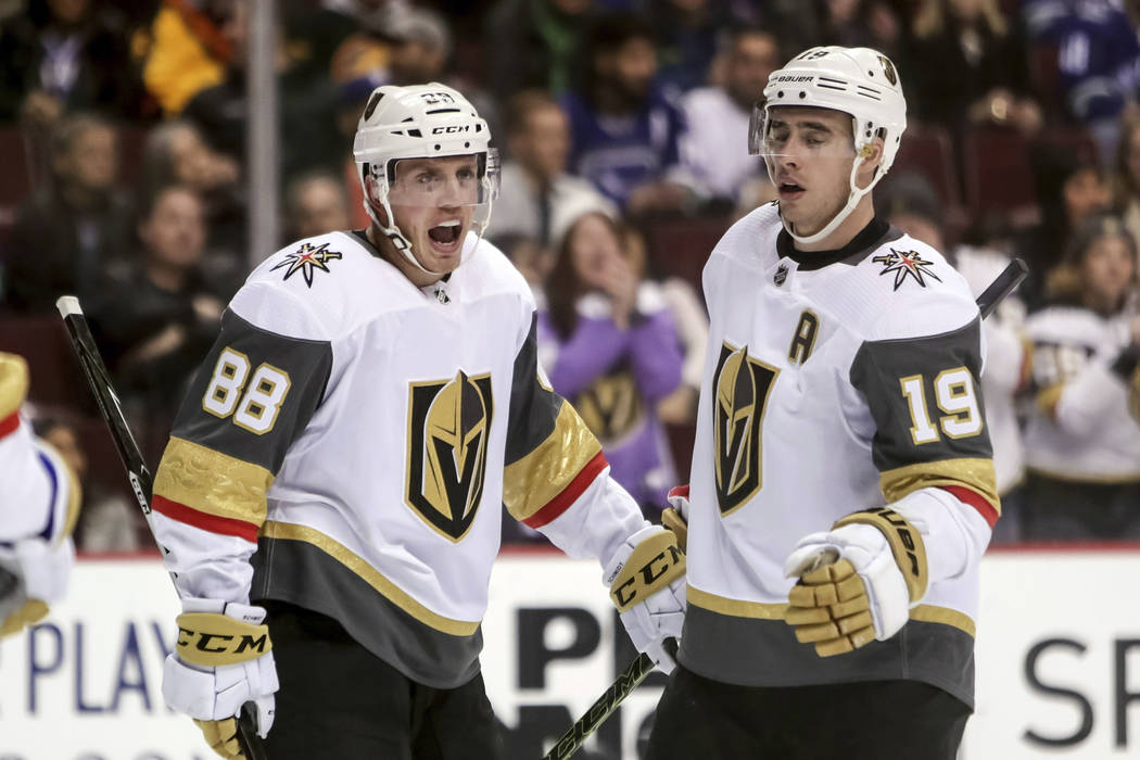 Vegas Golden Knights' Nate Schmidt (88) celebrates his goal with teammate Reilly Smith (19) during the second period of an NHL hockey game in Vancouver, British Columbia, Saturday, March 9, 2019. ...