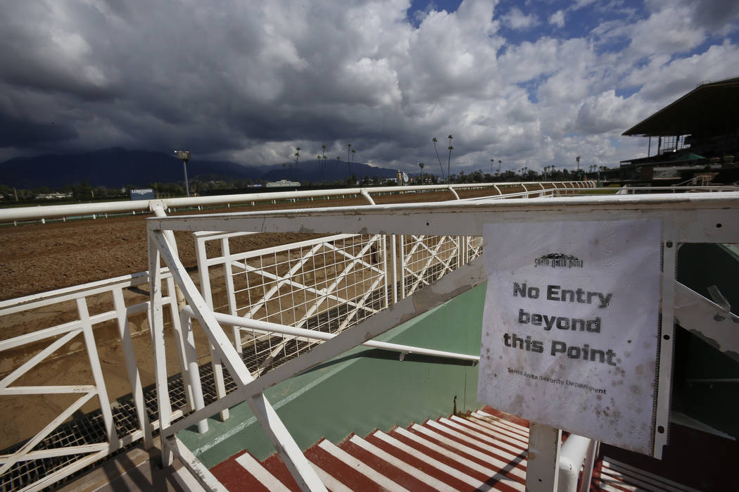 Heavy clouds are seen over the San Gabriel Mountains at Santa Anita Park in Arcadia, Calif., Thursday, March 7, 2019. Extensive testing of the dirt track is under way at eerily quiet Santa Anita, ...