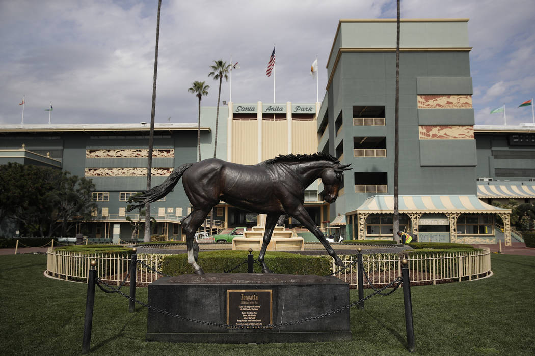 A statue of Zenyatta stands in the paddock gardens area at Santa Anita Park Tuesday, March 5, 2019, in Arcadia, Calif. A person with direct knowledge of the situation says a another horse has died ...