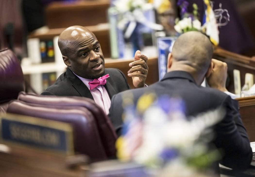 Sen. Kelvin Atkinson, D-North Las Vegas, left, speaks with Senate Majority Leader Aaron Ford, D-Las Vegas, in the Senate Chambers during the third day of the Nevada Legislative session on Wednesda ...