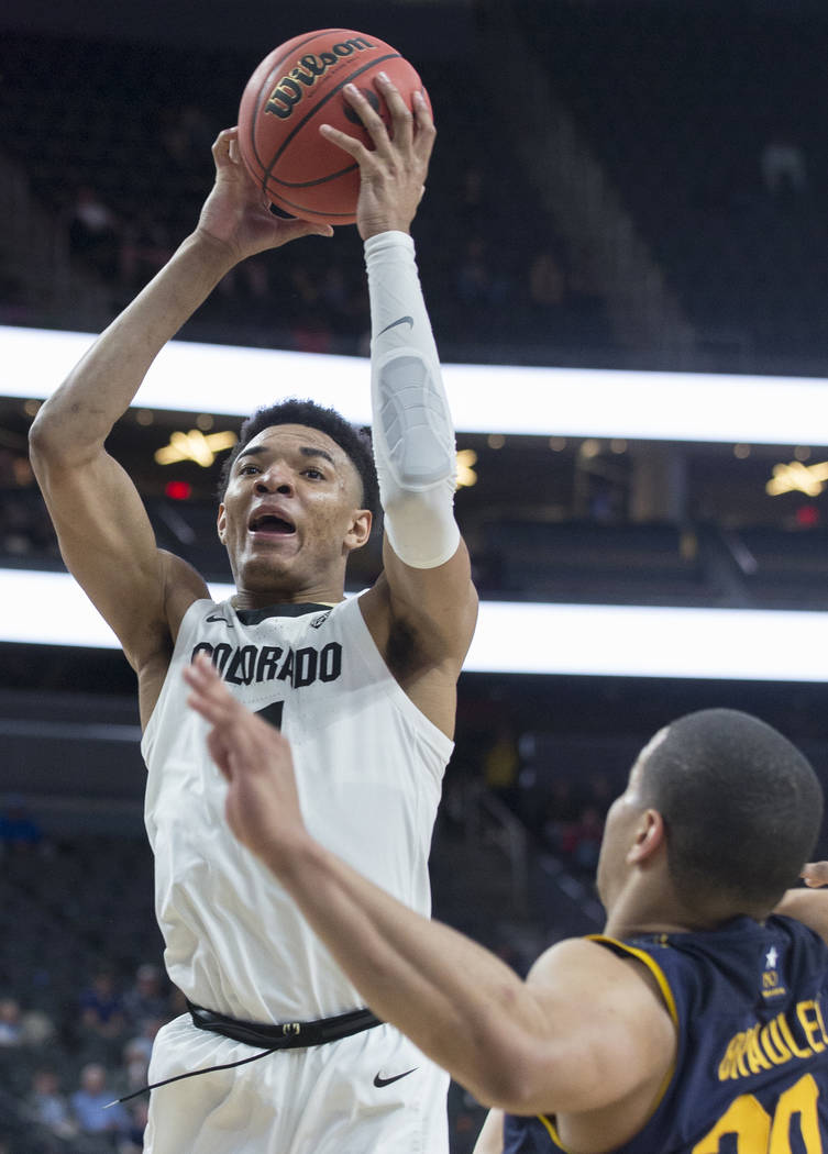 Colorado sophomore guard Tyler Bey (1), a Las Vegas native, drives over California freshman guard Matt Bradley (20) in the second half during the Buffalo's Pac-12 tournament game with the Bears on ...